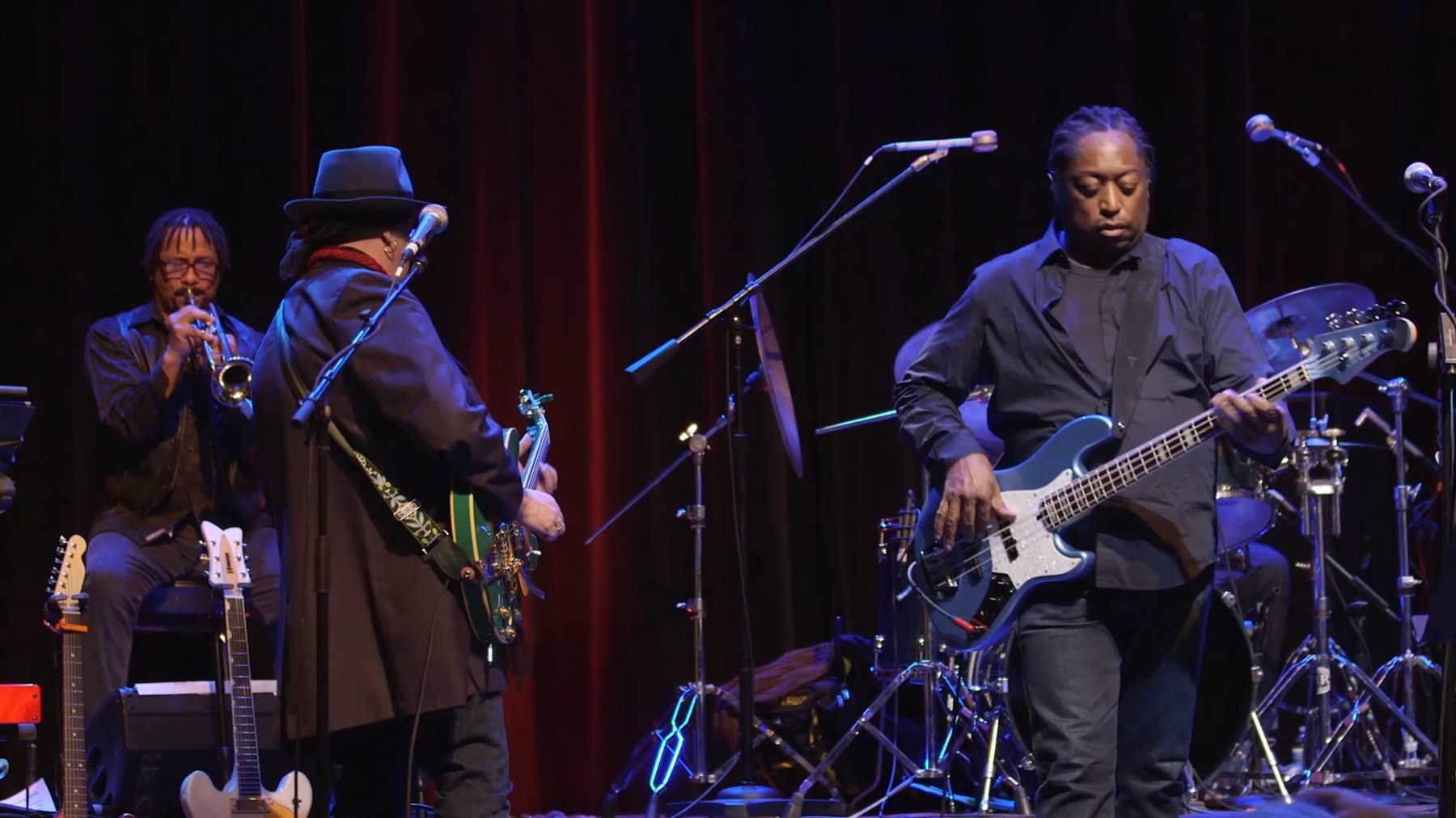 Darryl Jones performing on stage with a Jones bass